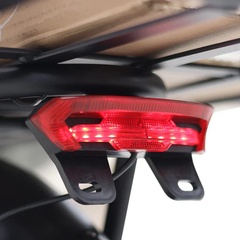 Red taillight on a motorcycle with a blurred background