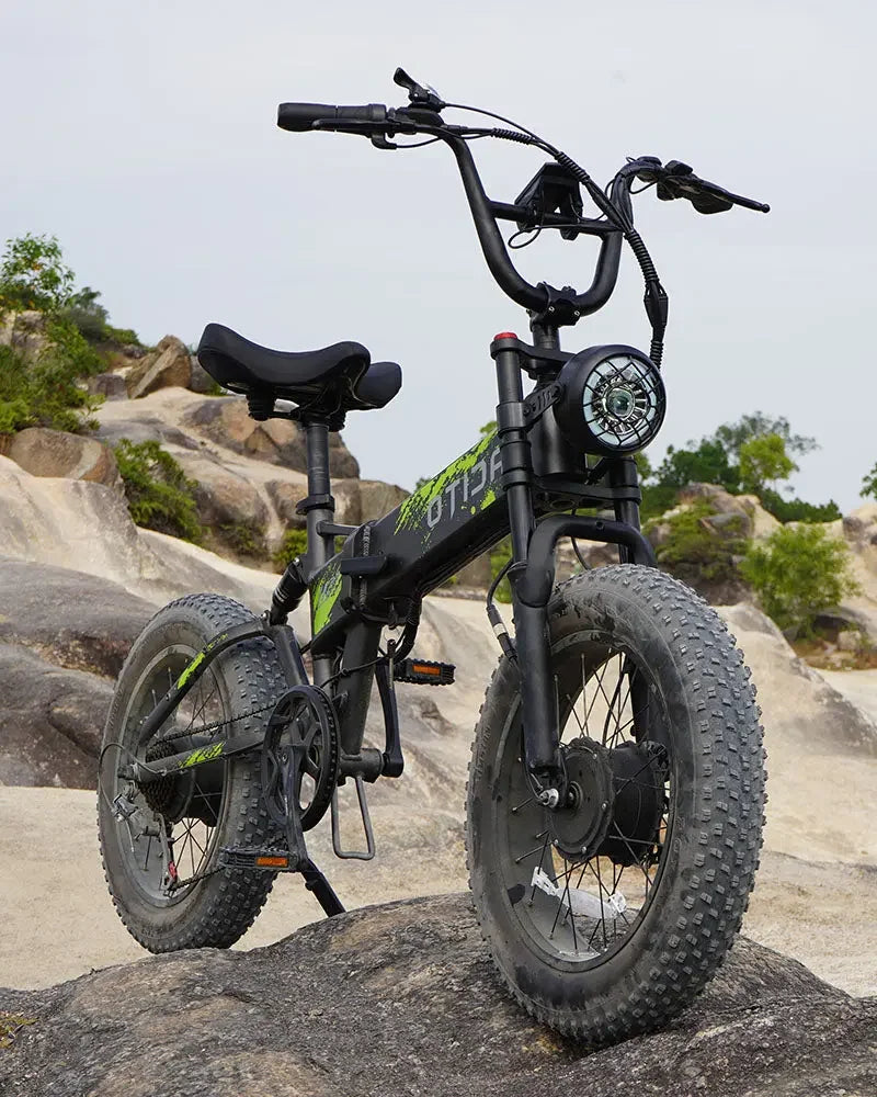 OTIDA R7 MAX Dual Motor Electric Bike with large wheels on a rocky outdoor background