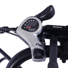 Close-up of a bicycle gear shifter with Shimano branding on a white background