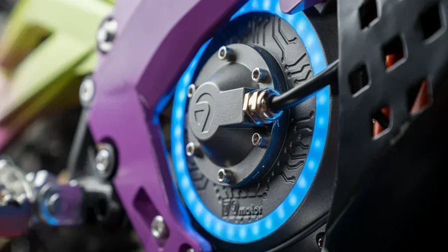 Close-up of a 79BIKE Falcon Pro Electric Dirt Bicycle wheel with purple and blue design