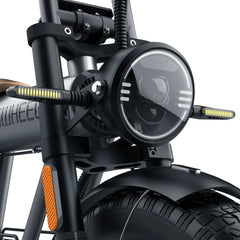 Close-up of a motorcycle headlight and front fork with 'HIMOTO' branding.