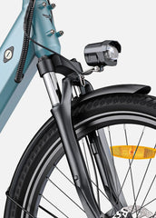 Close-up of a bicycle's front wheel and headlight on a light blue background