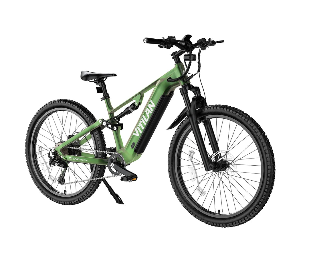 A green and black Vitilan M5 electric mountain bike with knobby tires, a front suspension fork, and a black battery pack mounted on the frame, shown against a solid white background.