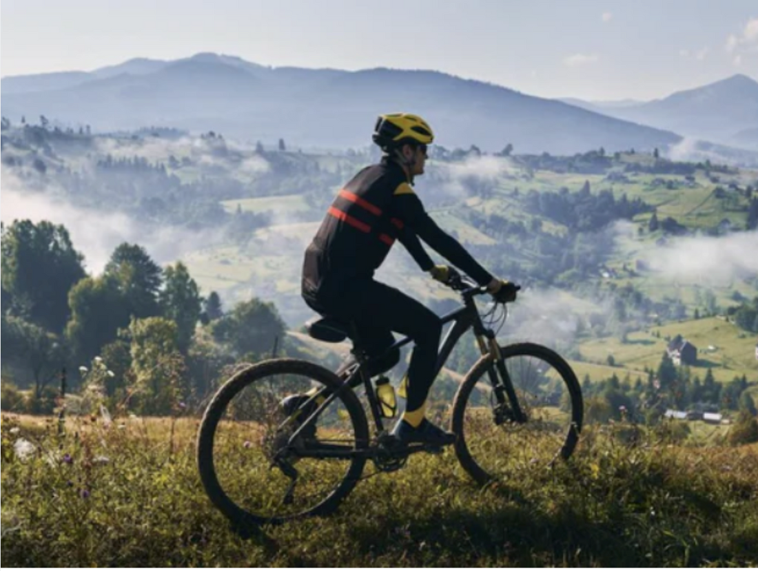 Cyclist riding electric bike outdoors on scenic mountain trail, Pogo Cycles e-bike adventure