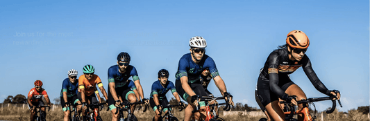 Cyclists riding electric bikes on a rural road, group wearing helmets and sports gear, side view