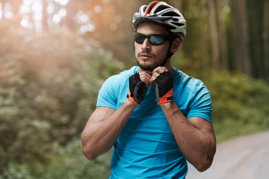 Man wearing e-bike helmet and sunglasses on a forest trail, Pogo Cycles safety gear