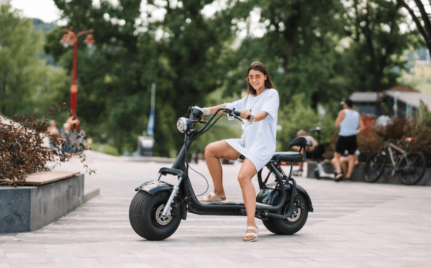 Woman riding electric bike outdoors, Pogo Cycles e bike store lifestyle image