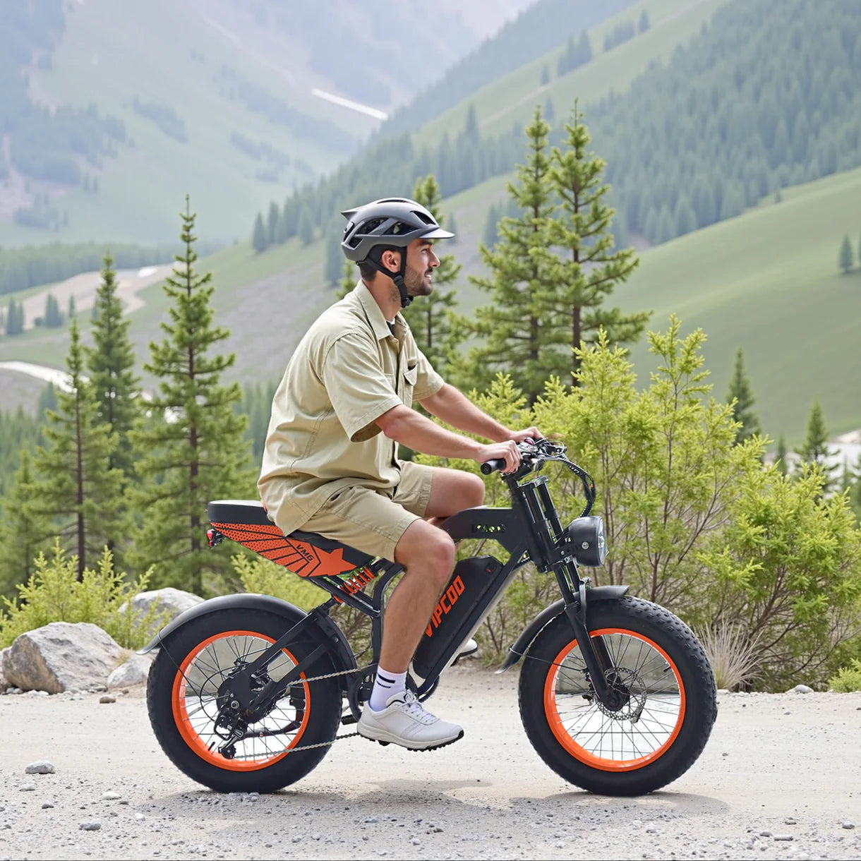 Person riding a VIPCOO VM6 Electric City bicycle on a mountain road with greenery in the background